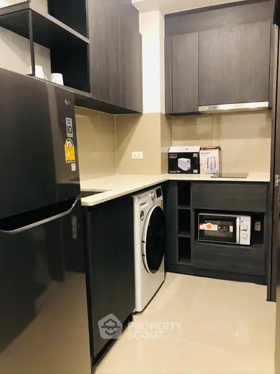 Modern kitchen with sleek black cabinets and built-in appliances