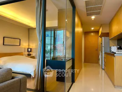 Modern studio apartment with open layout and city view, featuring a cozy bedroom and sleek kitchen.