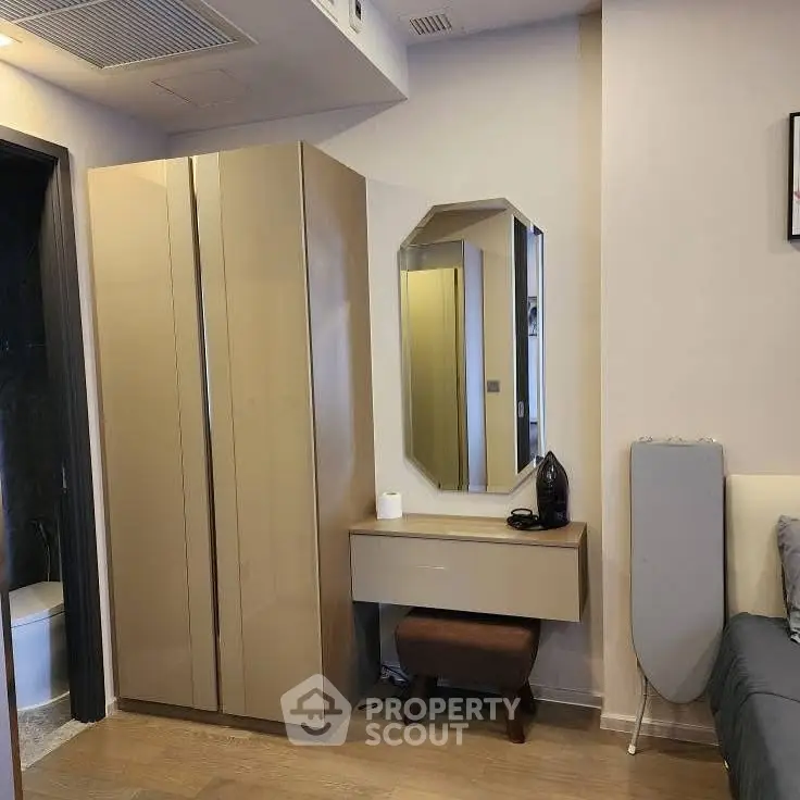 Modern bedroom corner with sleek wardrobe and stylish mirror