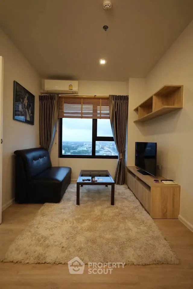 Modern living room with city view, cozy sofa, and stylish decor