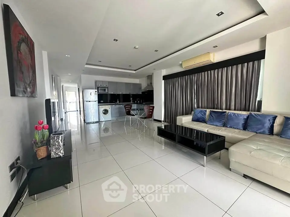 Spacious modern living room with open kitchen and sleek furnishings