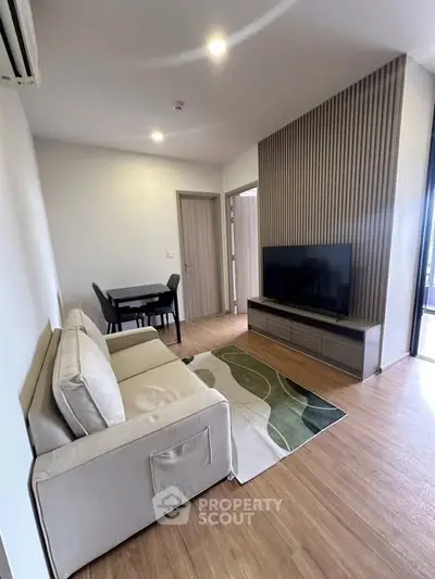 Modern living room with sleek TV setup and cozy seating area