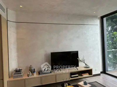 Modern living room with sleek TV setup and natural light