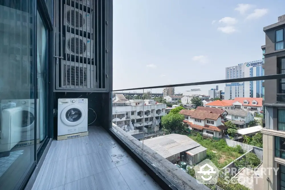 Modern balcony with city view and washing machine in urban apartment