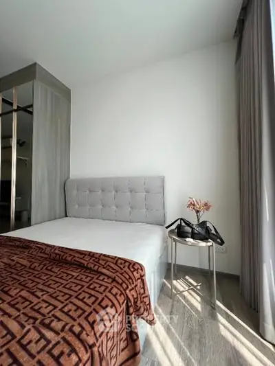 Modern bedroom with stylish decor and natural light