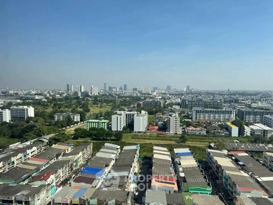 Stunning cityscape view showcasing vibrant urban skyline and residential buildings under a clear blue sky.