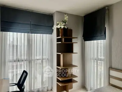 Modern bedroom with stylish shelving and large windows offering city views.