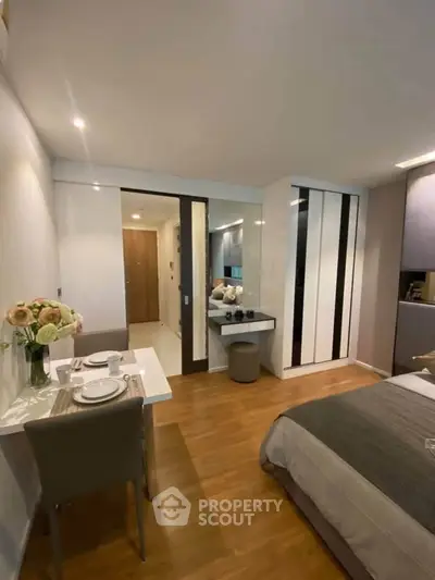 Modern bedroom with dining area and stylish decor in a cozy apartment.