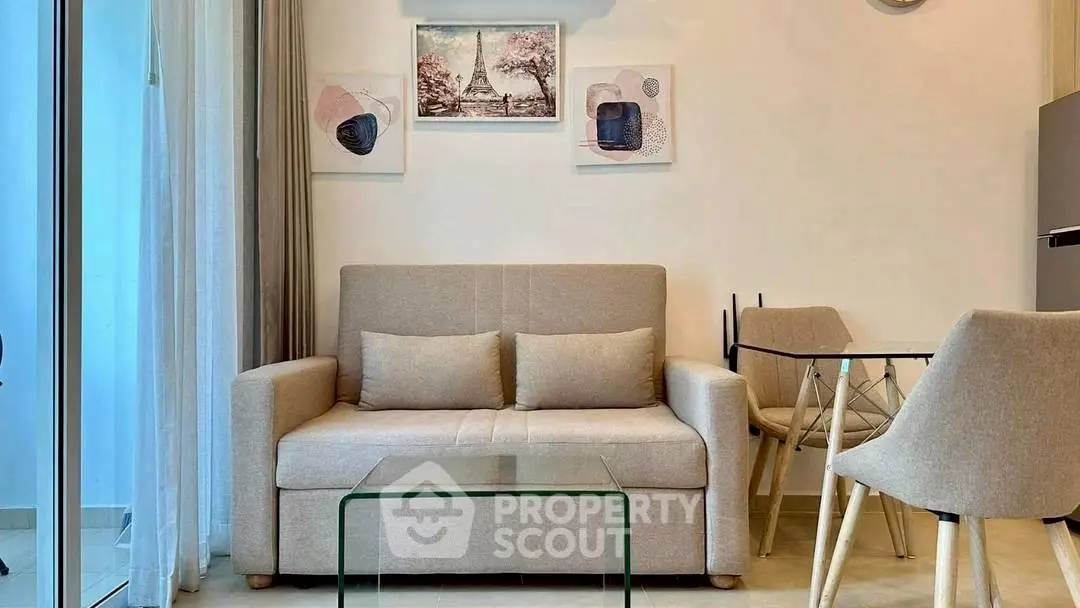 Modern living room with cozy sofa, glass coffee table, and stylish decor.