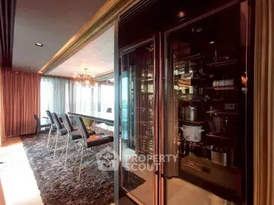 Luxurious dining area with modern decor and large windows offering natural light.