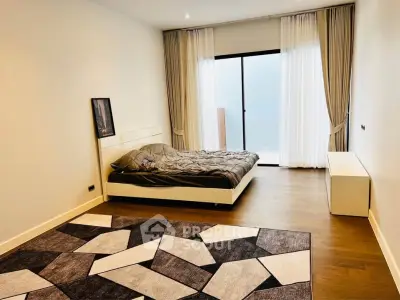 Spacious modern bedroom with large window and stylish decor