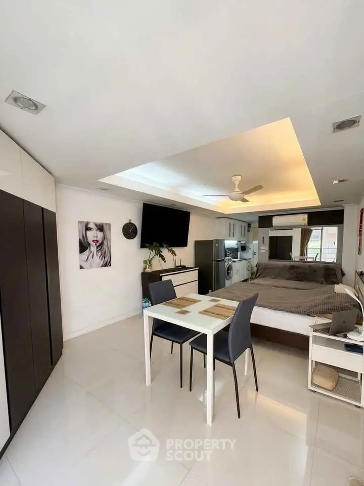 Modern studio apartment with sleek design and open layout, featuring a cozy dining area and stylish decor.