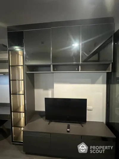 Modern living room with sleek black entertainment unit and TV