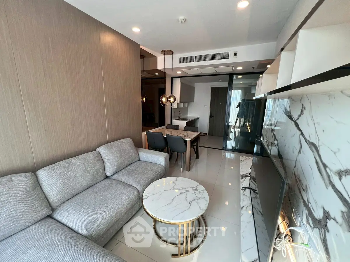 Modern living room with elegant marble accents and cozy seating area