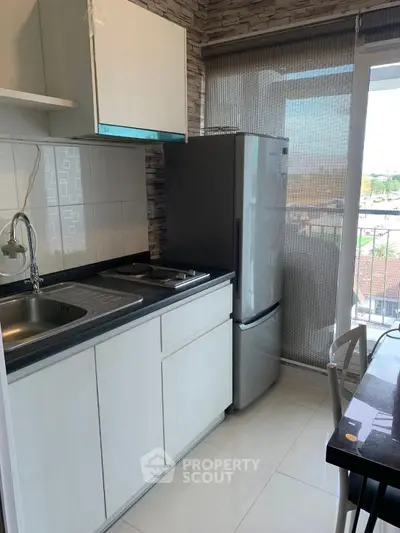 Modern kitchen with sleek appliances and large window view