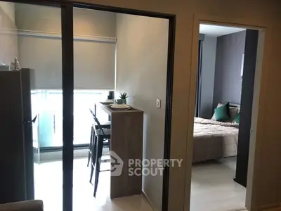 Modern apartment interior with cozy bedroom and dining area, featuring sleek design and natural light.