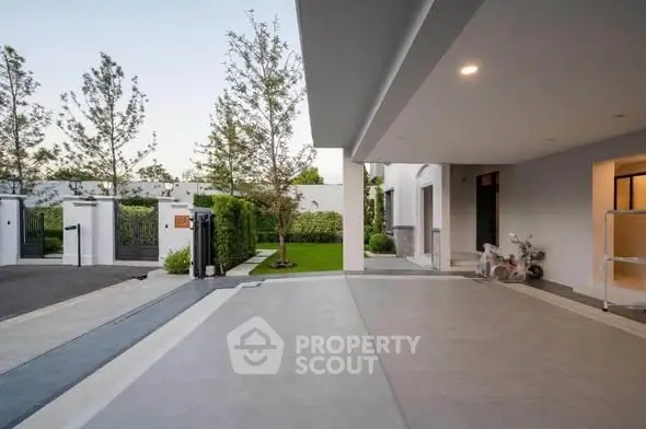 Modern residential driveway with sleek design and lush greenery