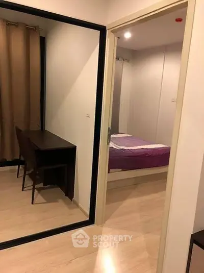 Modern apartment interior with bedroom and study area, featuring sleek design and cozy ambiance.