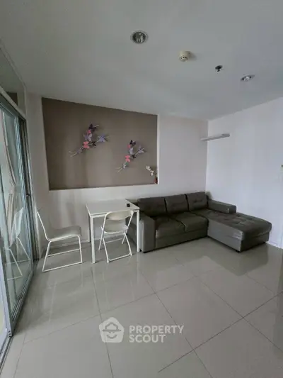 Modern living room with sleek sofa and dining area in open layout
