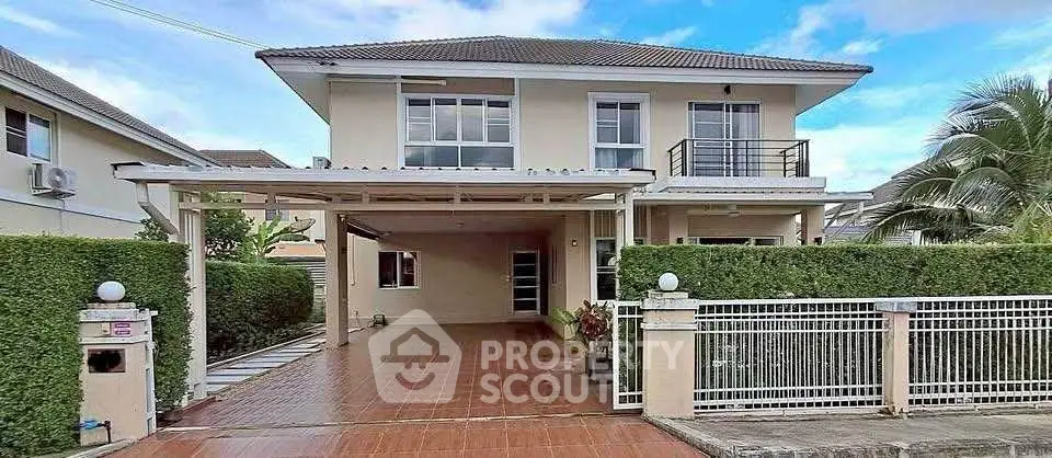 Charming two-story house with spacious driveway and lush greenery in a serene neighborhood.