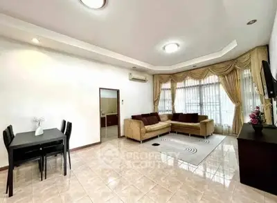 Spacious living room with elegant curtains and modern furniture