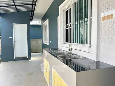Modern outdoor kitchen with sleek countertops and stylish design, perfect for entertaining guests.