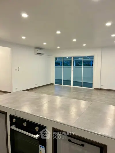 Spacious modern living room with open layout and sleek kitchen design