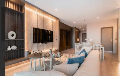 Modern living room with stylish decor, cozy seating, and elegant lighting in a contemporary apartment.