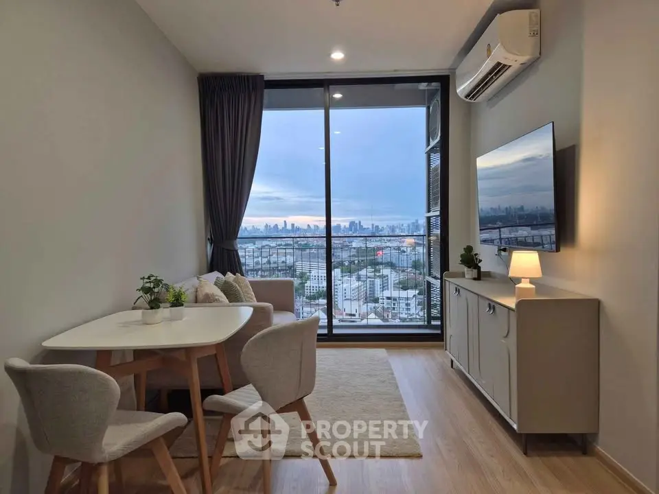 Modern living room with city view, featuring sleek furniture and large windows for natural light.