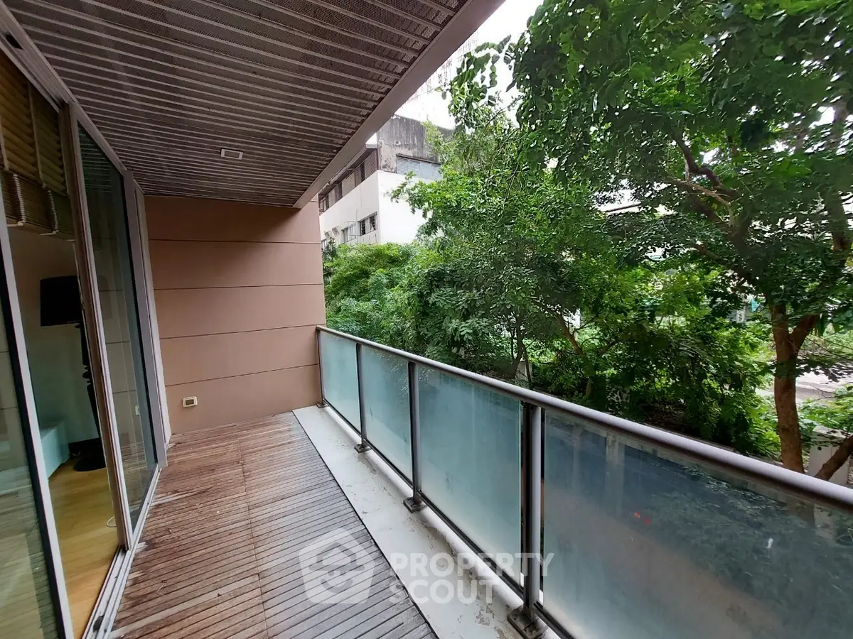 Spacious balcony with lush green view in modern apartment