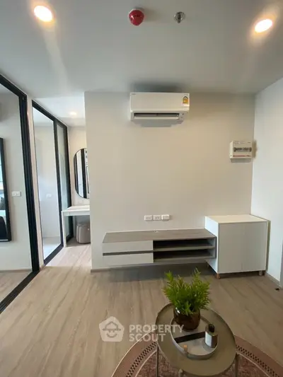 Modern living room with sleek furniture and air conditioning in a stylish apartment.