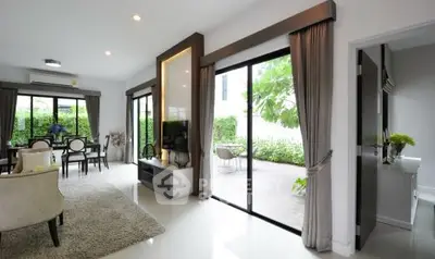 Spacious modern living room with garden view and elegant dining area