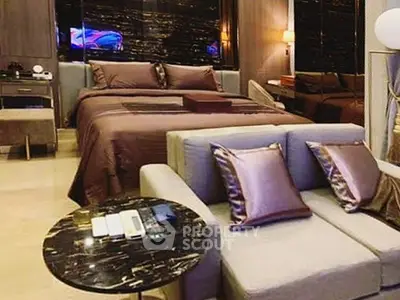 Luxurious bedroom with elegant decor and plush bedding in modern apartment.