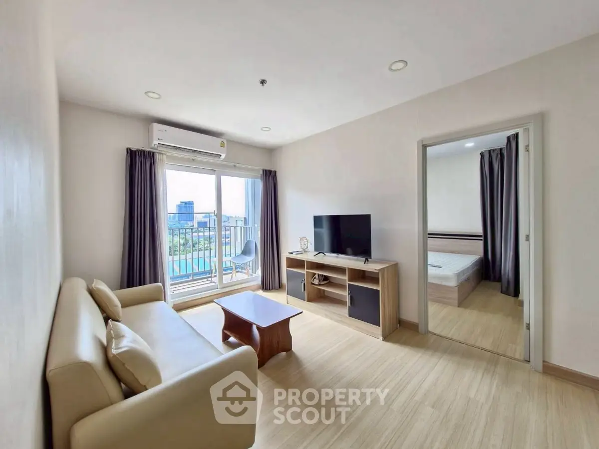 Modern living room with balcony view and cozy furniture in a stylish apartment.