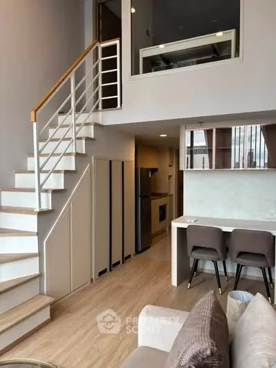 Modern loft apartment with stylish staircase and open kitchen layout