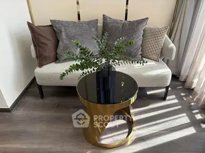 Stylish modern living room with elegant sofa and chic gold coffee table, perfect for contemporary interiors.
