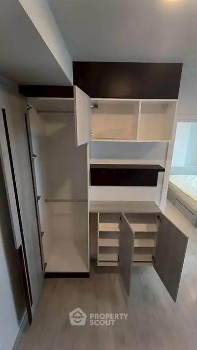 Spacious modern wardrobe with open shelves and ample storage in a stylish bedroom.