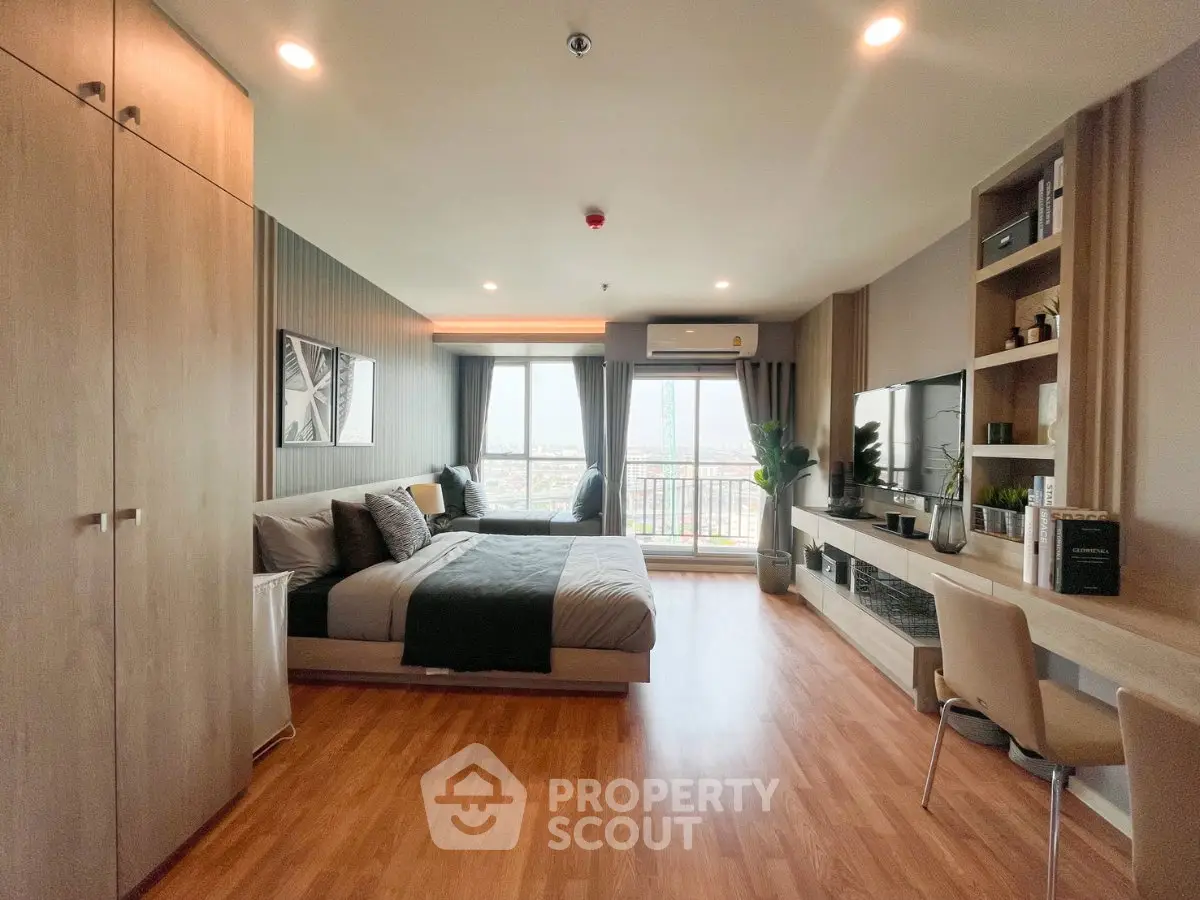 Spacious modern studio apartment with elegant decor and city view balcony.