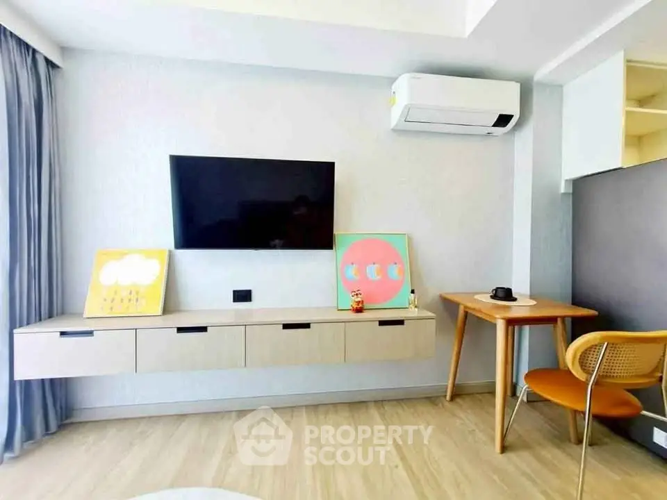 Modern living room with wall-mounted TV and stylish furniture