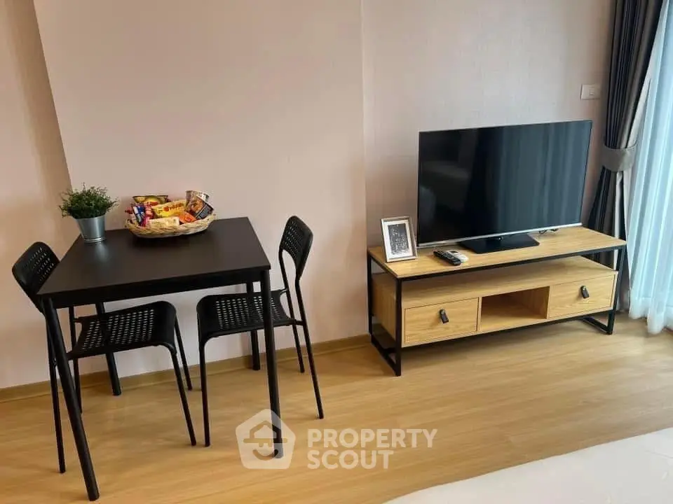 Modern living room with sleek TV stand and cozy dining area