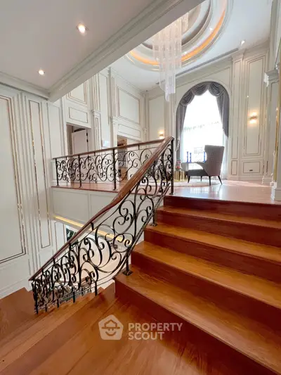 Luxurious staircase with elegant railing and chandelier in a grand living space