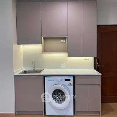 Modern kitchen with integrated washing machine and sleek cabinetry