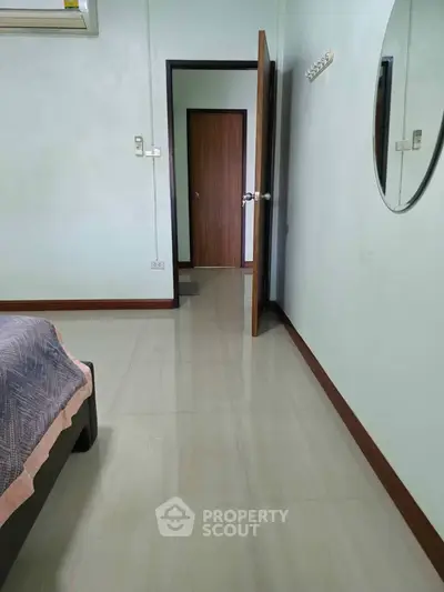 Spacious bedroom with modern decor and polished flooring