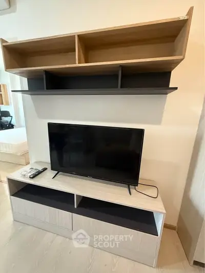 Modern living room with sleek TV stand and wall-mounted shelves