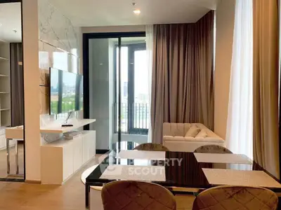 Modern living room with elegant decor and large windows offering city views.