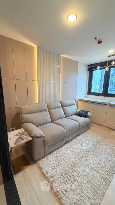 Modern living room with cozy sofa and city view, perfect for urban living.