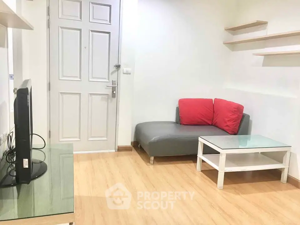 Cozy living room with modern furniture and wooden flooring, perfect for relaxation.