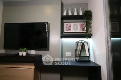 Modern living room with wall-mounted TV, stylish shelves, and decorative plants.
