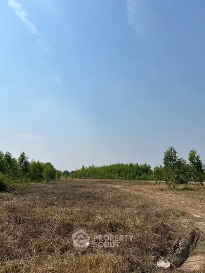 Expansive land plot with clear skies, ideal for development or investment opportunities.