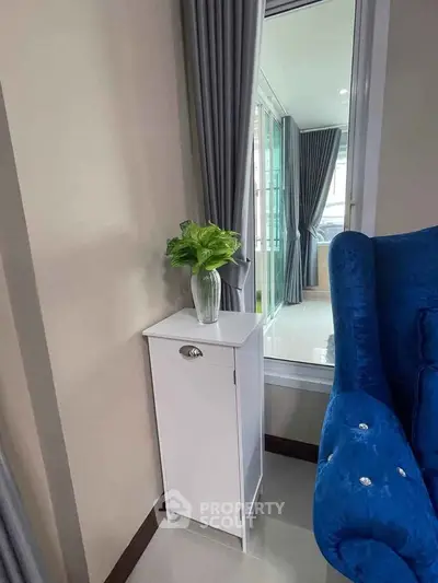 Chic modern living room corner with plush blue chair and elegant decor